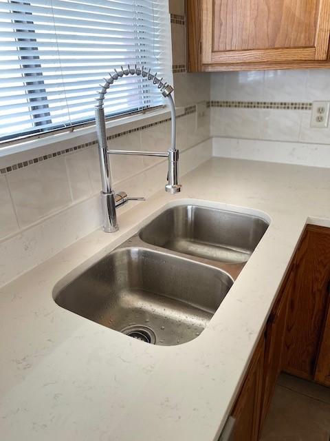 interior details with backsplash and sink