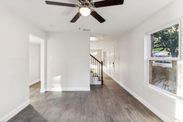 unfurnished room featuring ceiling fan and dark hardwood / wood-style flooring