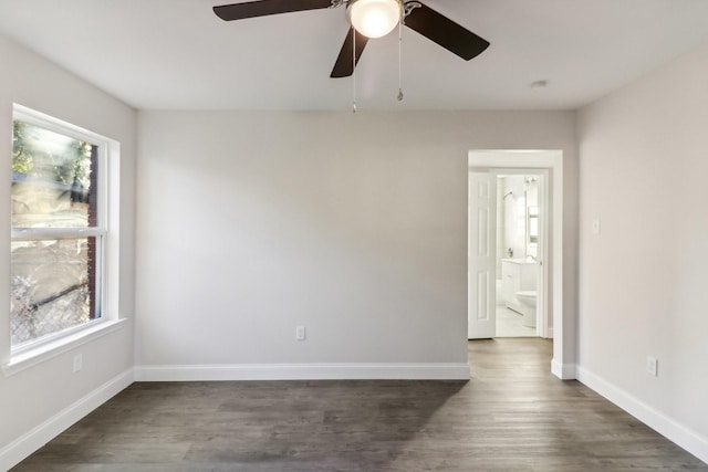 unfurnished room with dark hardwood / wood-style flooring and ceiling fan