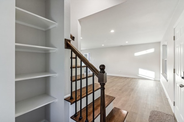 staircase with hardwood / wood-style flooring