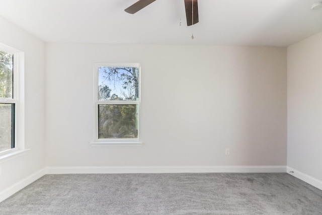 carpeted spare room with ceiling fan