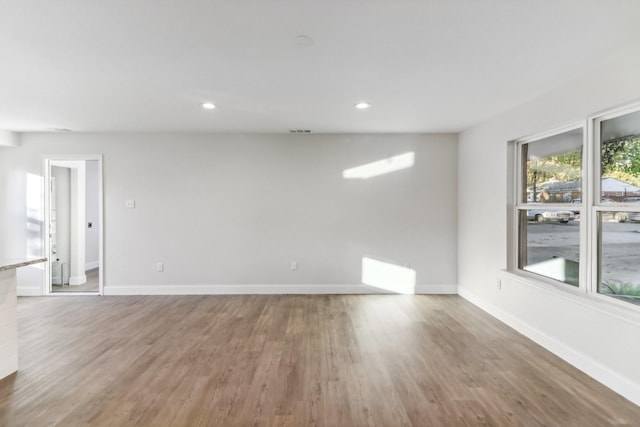 unfurnished room with hardwood / wood-style flooring