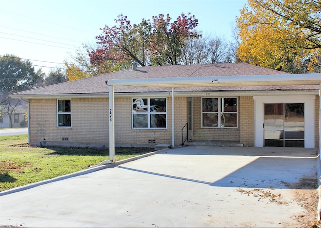 back of property with a carport and a lawn