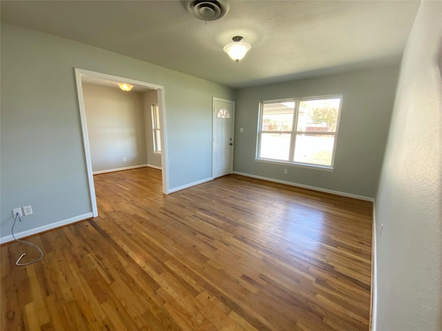 empty room featuring dark hardwood / wood-style flooring