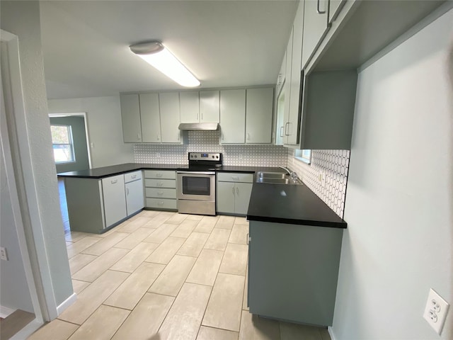 kitchen with tasteful backsplash, gray cabinets, sink, and stainless steel range with electric stovetop