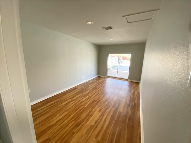 unfurnished room featuring hardwood / wood-style flooring