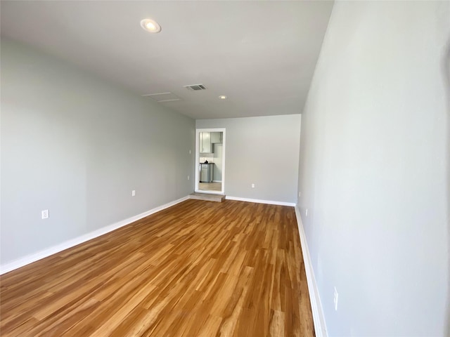 unfurnished room with light wood-type flooring