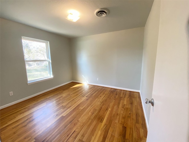 unfurnished room featuring wood-type flooring