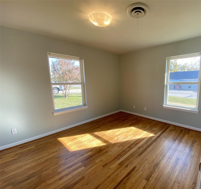 empty room with hardwood / wood-style flooring