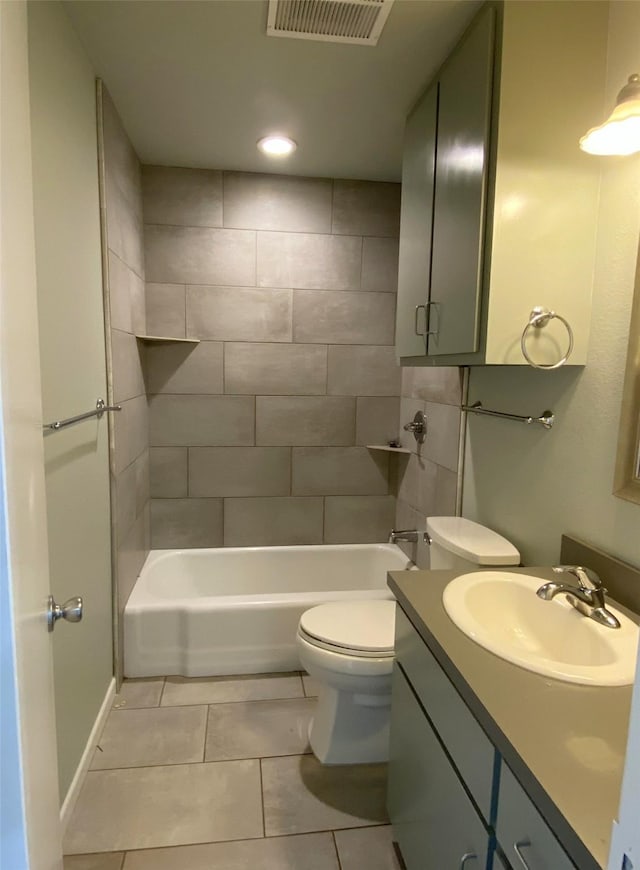 full bathroom featuring toilet, vanity, tile patterned floors, and tiled shower / bath combo