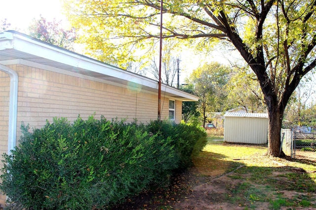 view of home's exterior with a storage unit