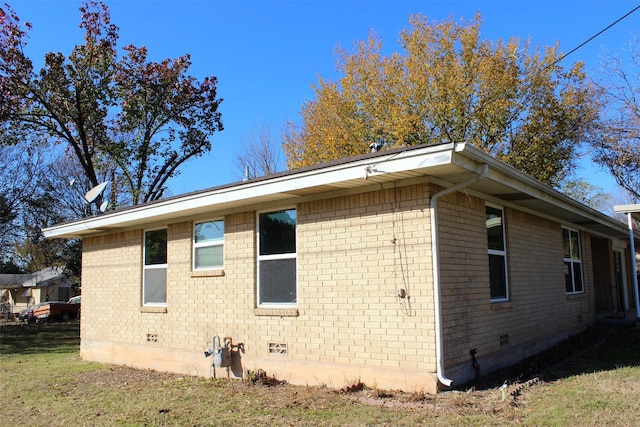 view of side of home featuring a lawn