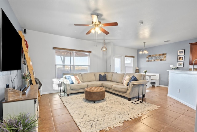 living room with ceiling fan with notable chandelier and light tile patterned flooring