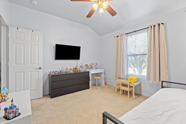 bedroom with vaulted ceiling, light colored carpet, and ceiling fan