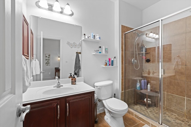 bathroom with vanity, tile patterned flooring, a shower with door, and toilet