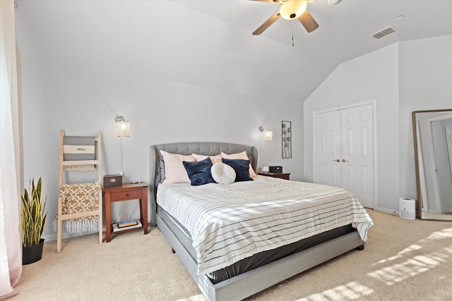 carpeted bedroom featuring ceiling fan, a closet, and lofted ceiling