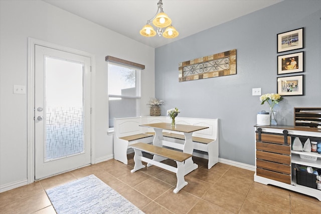 tiled dining room featuring a notable chandelier