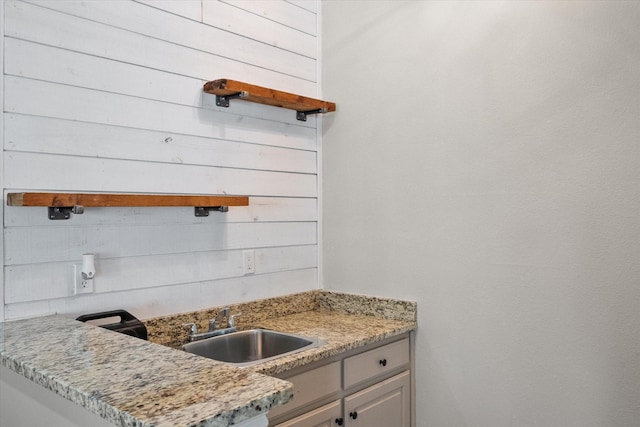 kitchen with sink and light stone counters