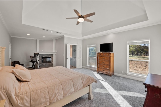 bedroom featuring ornamental molding, light carpet, and a tray ceiling