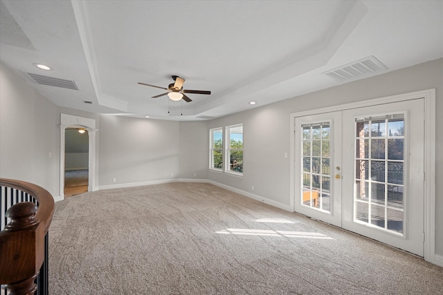 spare room with french doors, carpet, ceiling fan, and a tray ceiling