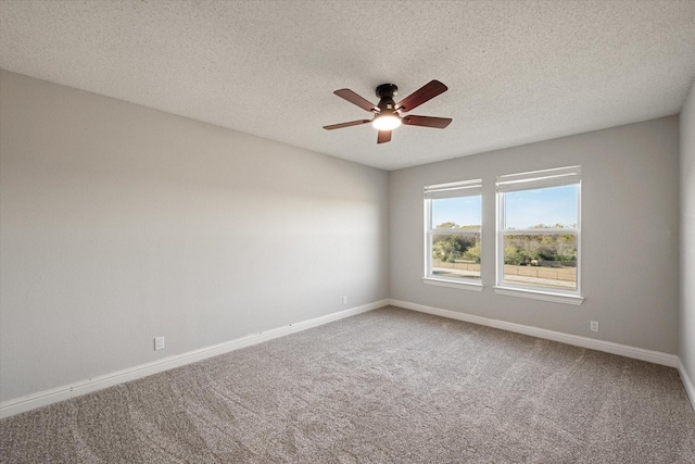 carpeted spare room featuring a textured ceiling and ceiling fan