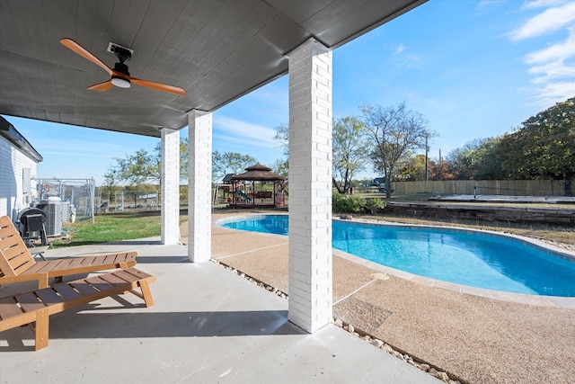 view of pool with a gazebo, a patio area, ceiling fan, and central air condition unit