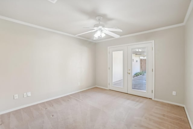 empty room with french doors, light colored carpet, ceiling fan, and ornamental molding