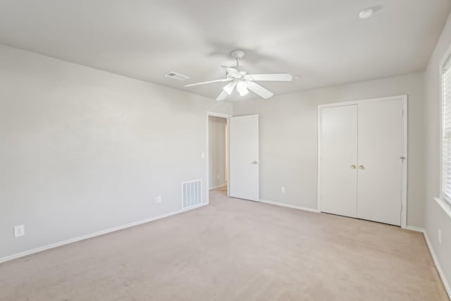 unfurnished bedroom featuring ceiling fan and light carpet