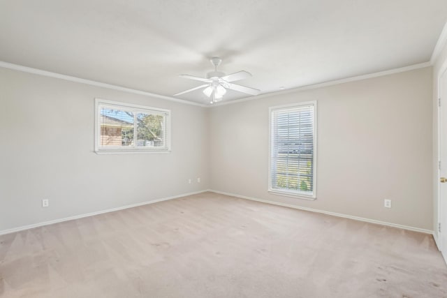 carpeted spare room featuring ceiling fan and ornamental molding