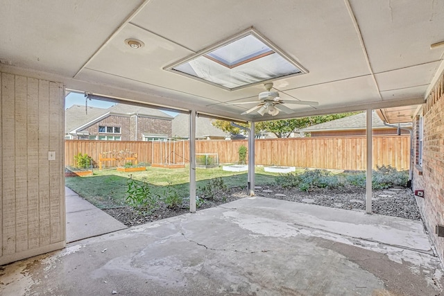 unfurnished sunroom with a skylight and ceiling fan