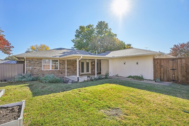 single story home with a patio area and a front lawn