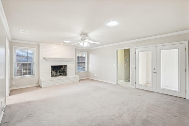 unfurnished living room featuring ornamental molding, light colored carpet, and a brick fireplace