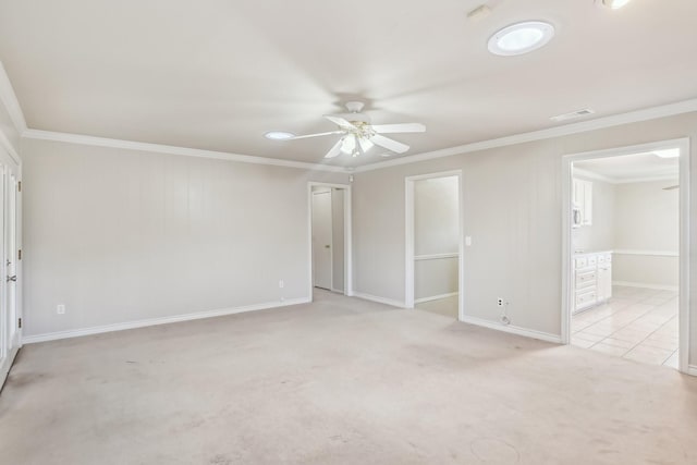 unfurnished room with light colored carpet, ceiling fan, and ornamental molding