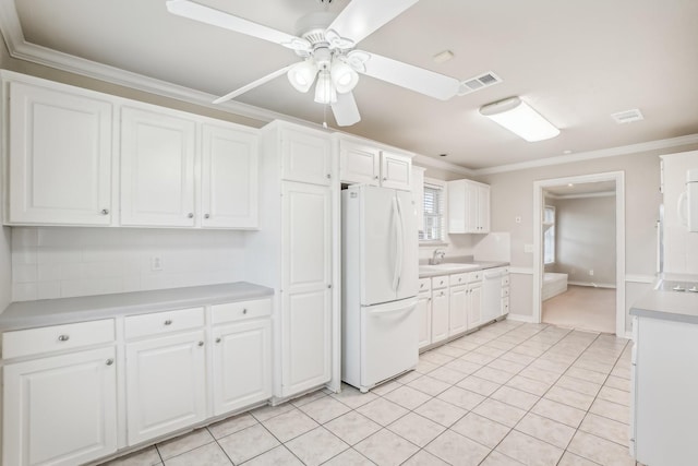 kitchen featuring ceiling fan, white cabinets, ornamental molding, and white refrigerator