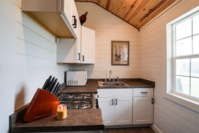 kitchen with white cabinetry, lofted ceiling, sink, and wooden ceiling