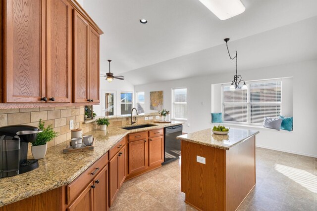 kitchen featuring dishwasher, sink, lofted ceiling, a kitchen island, and ceiling fan with notable chandelier