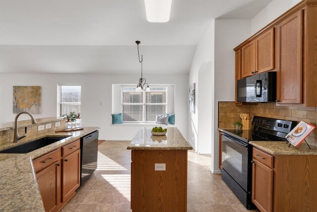 kitchen with sink, a chandelier, decorative light fixtures, a kitchen island, and black appliances