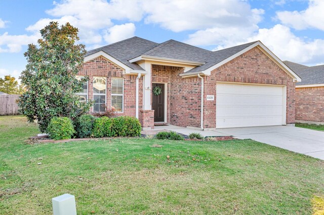 view of front of house with a front yard and a garage