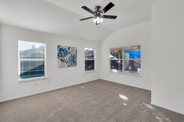 carpeted empty room with ceiling fan and vaulted ceiling