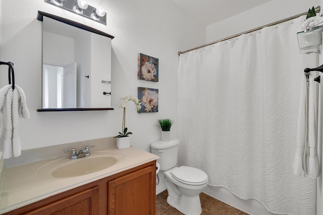 bathroom featuring toilet, vanity, tile patterned floors, and a shower with shower curtain