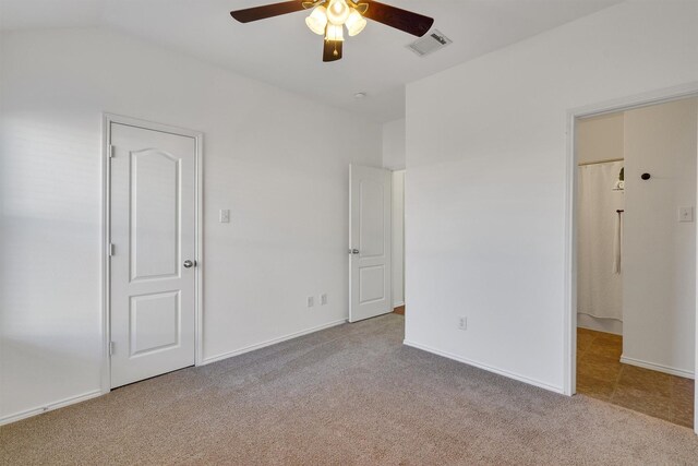 unfurnished bedroom with light colored carpet, ceiling fan, and lofted ceiling