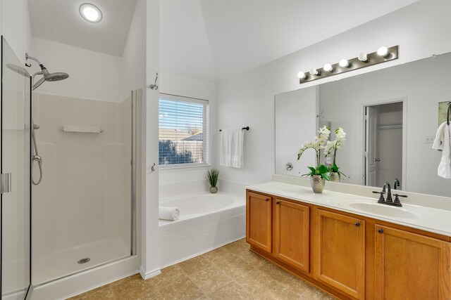 bathroom with vanity, plus walk in shower, and vaulted ceiling