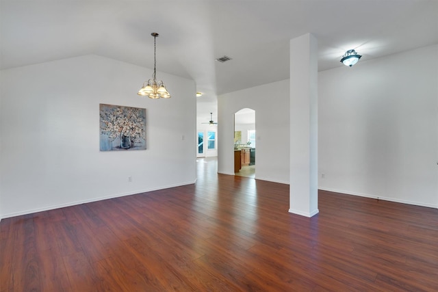 spare room with dark hardwood / wood-style flooring and ceiling fan with notable chandelier