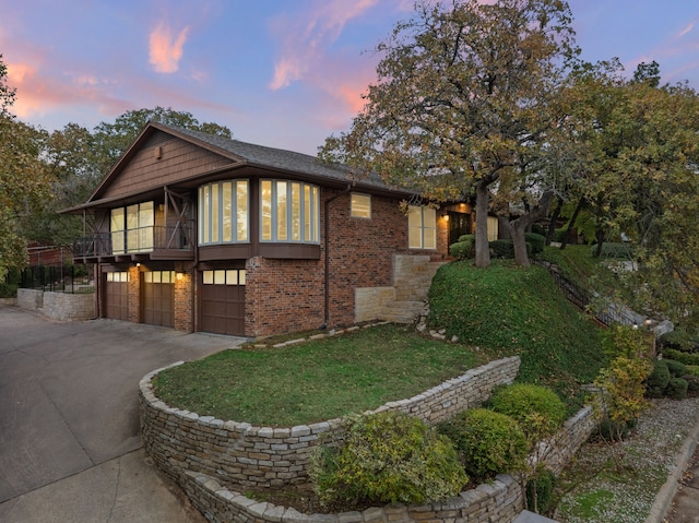 view of front of home with a garage and a balcony