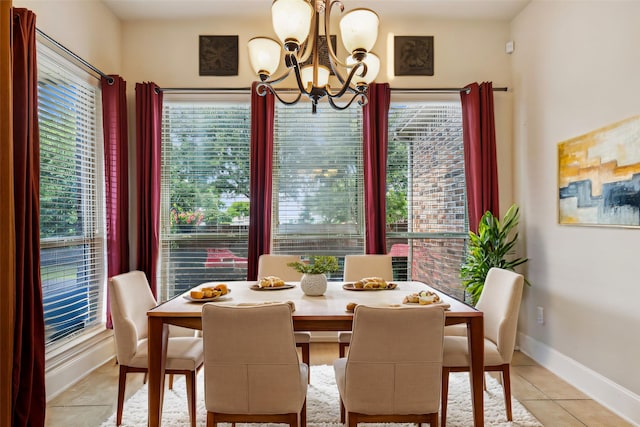 dining space with a notable chandelier and light tile patterned floors