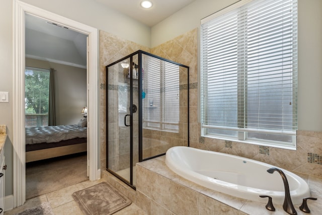 bathroom with plus walk in shower, tile patterned floors, plenty of natural light, and crown molding