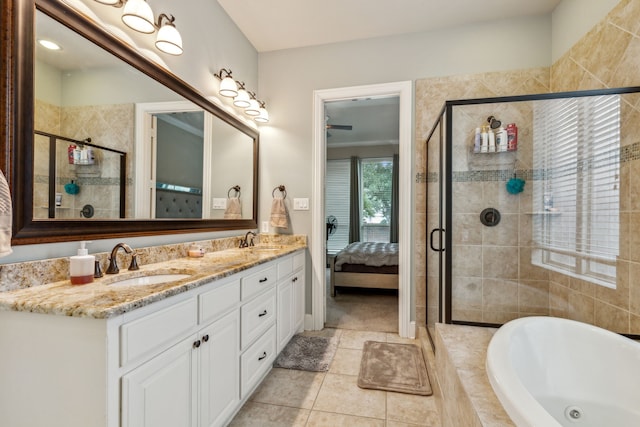 bathroom with tile patterned floors, vanity, and shower with separate bathtub