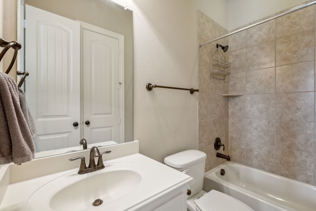 full bathroom with toilet, vanity, and tiled shower / bath combo