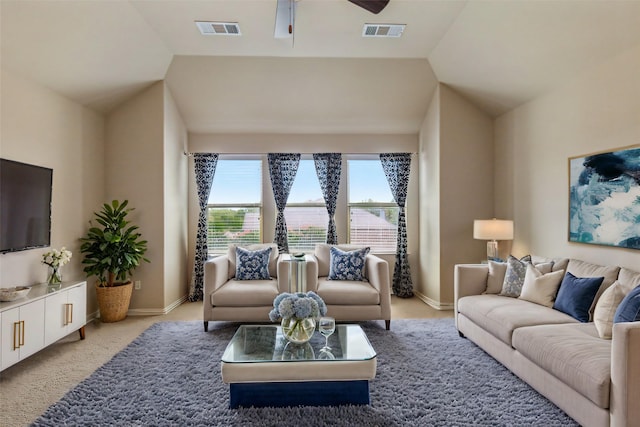 living room featuring ceiling fan, light carpet, and vaulted ceiling