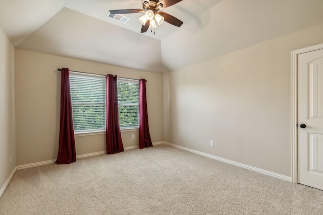 unfurnished room featuring ceiling fan, light carpet, and vaulted ceiling